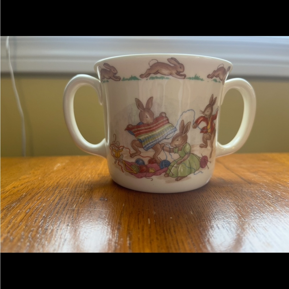 Royal Doulton Bunnykins two-handled "Hug-a-Mug" in the "Knitting" scene.